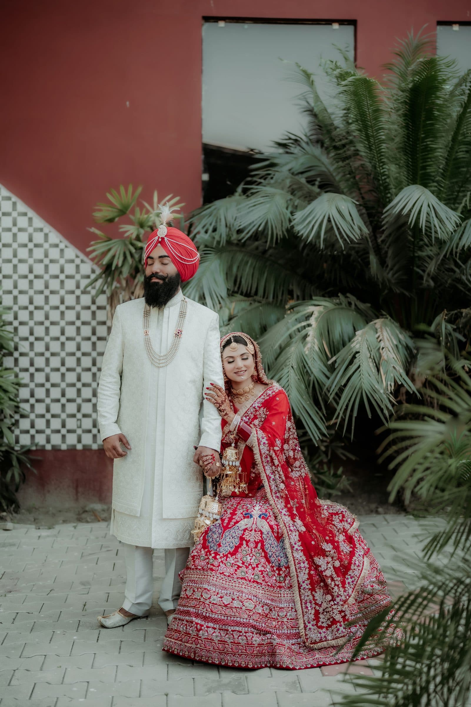 A bride and groom photographed together in a golden mustard field