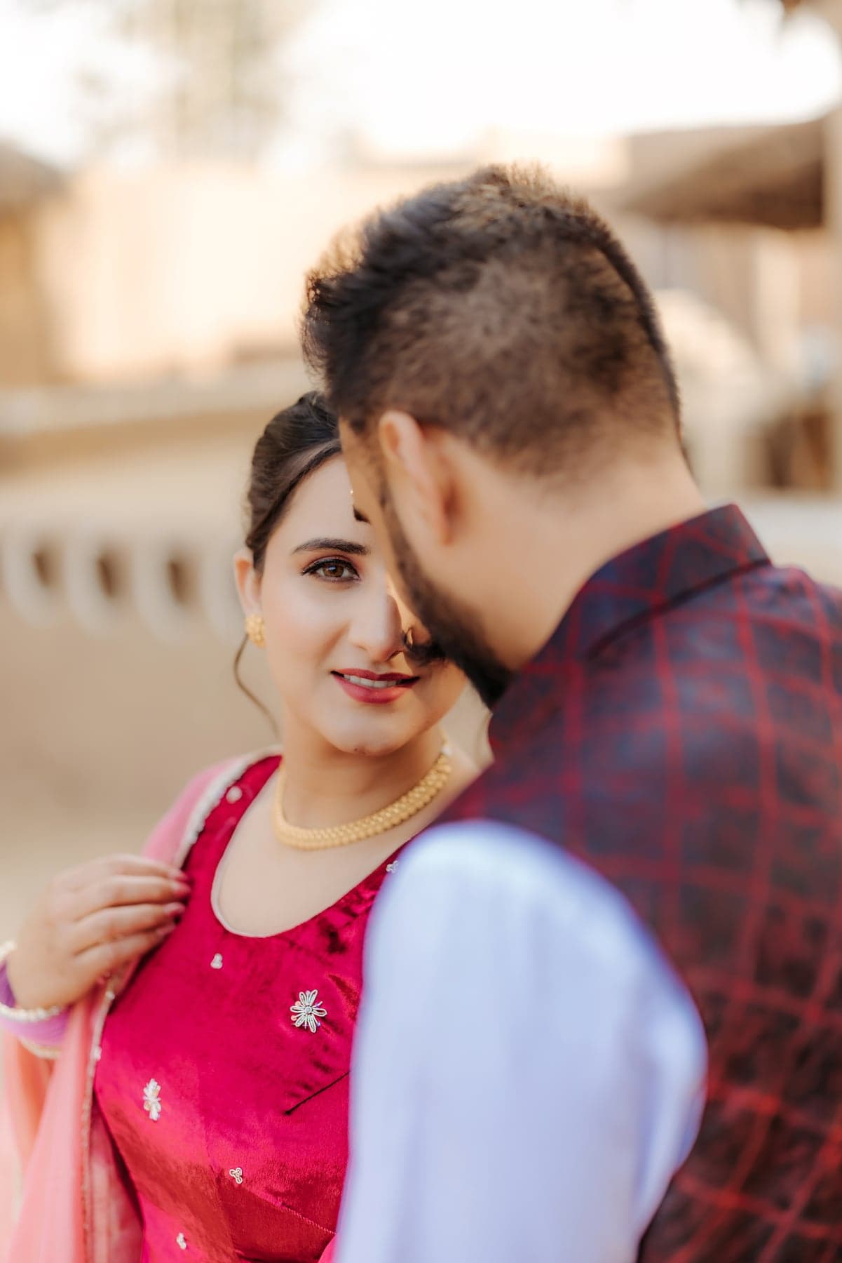 A close candid portrait of a couple, foreheads nearly touching
