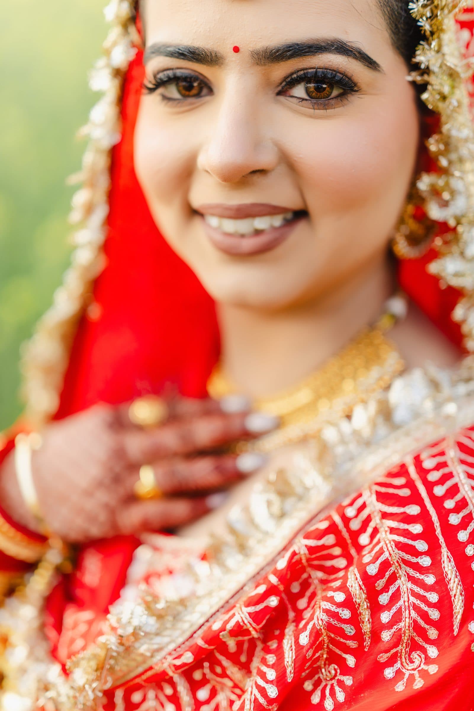 A close bridal portrait with a red veil